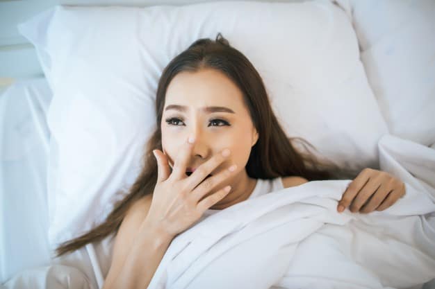 a woman going to sleep with make-up still on